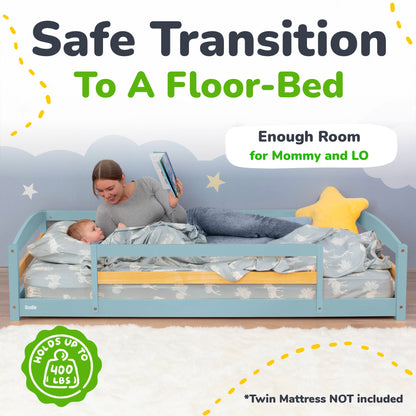 Child reading to a baby in a floor-bed with text about safe transition to a floor-bed.