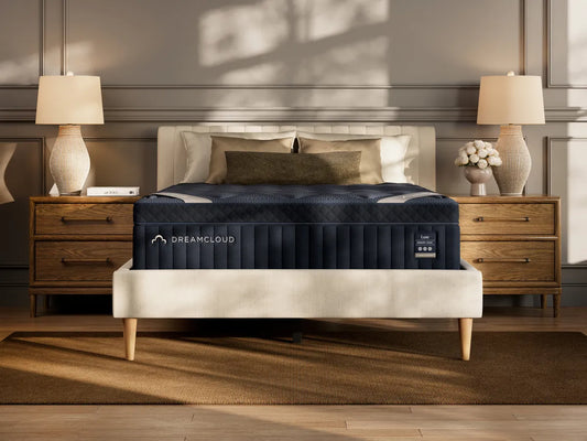 DreamCloud mattress on a bed in a bedroom setting with lamps and decor.