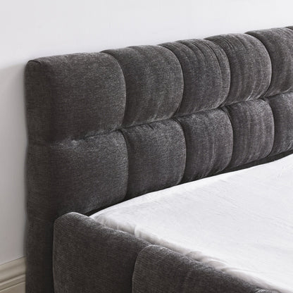 Luxury queen gray tufted headboard on a bed with white bedding.