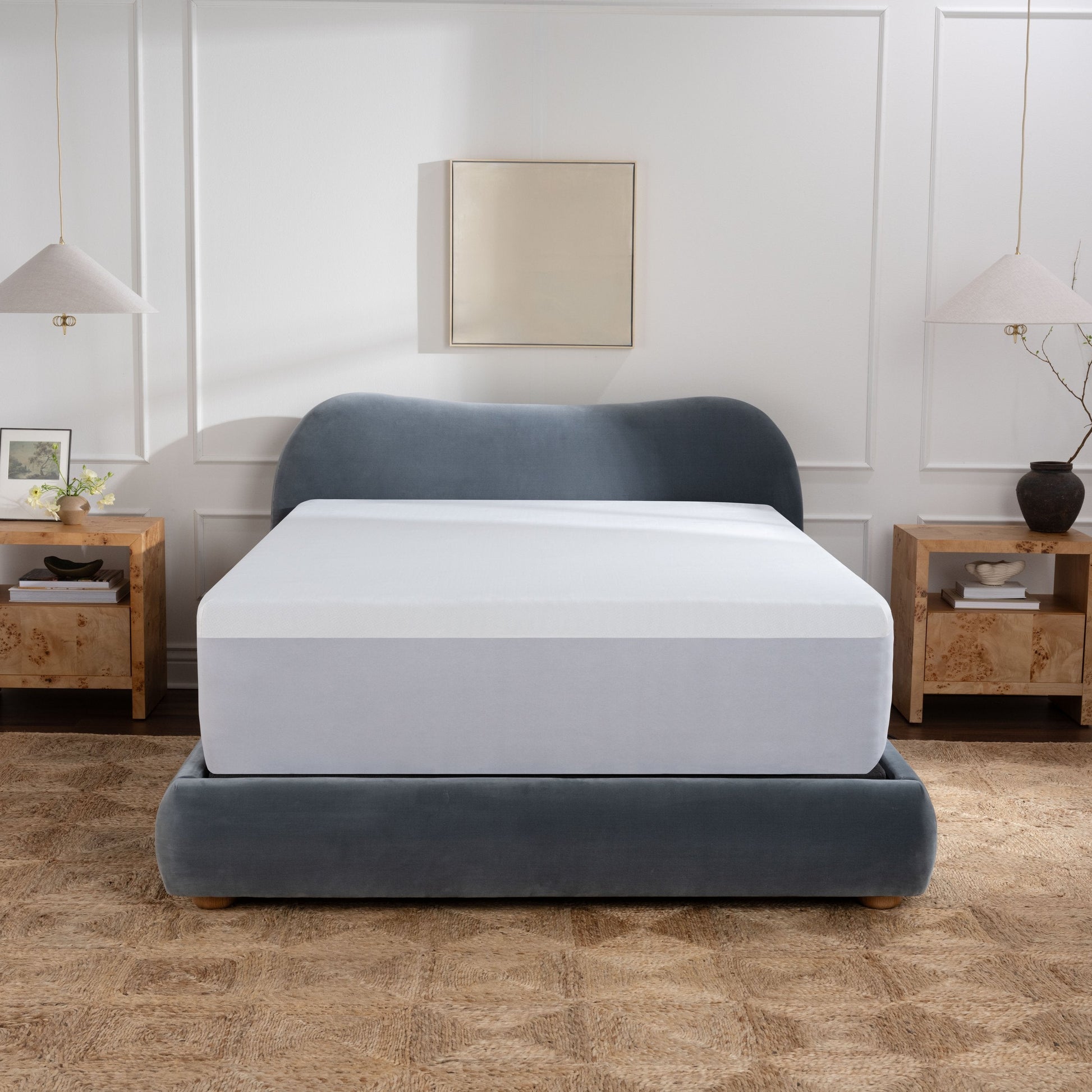 Waterproof mattress protector on purple mattress in bedroom