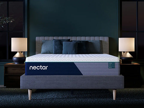 Nectar mattress on a bed in a darkly decorated room with two lamps.