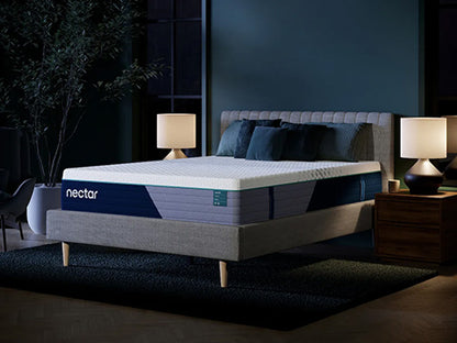 Nectar mattress on a bed in a dimly lit bedroom with two lamps and a plant.