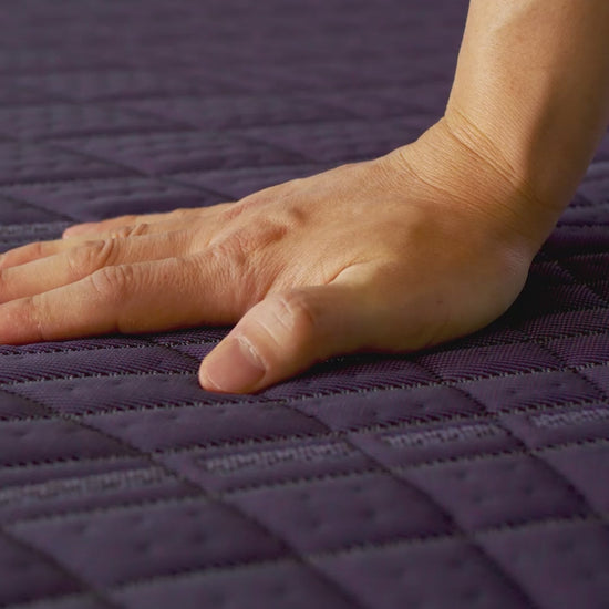 hand demonstrating softness of the purple ultimate mattress