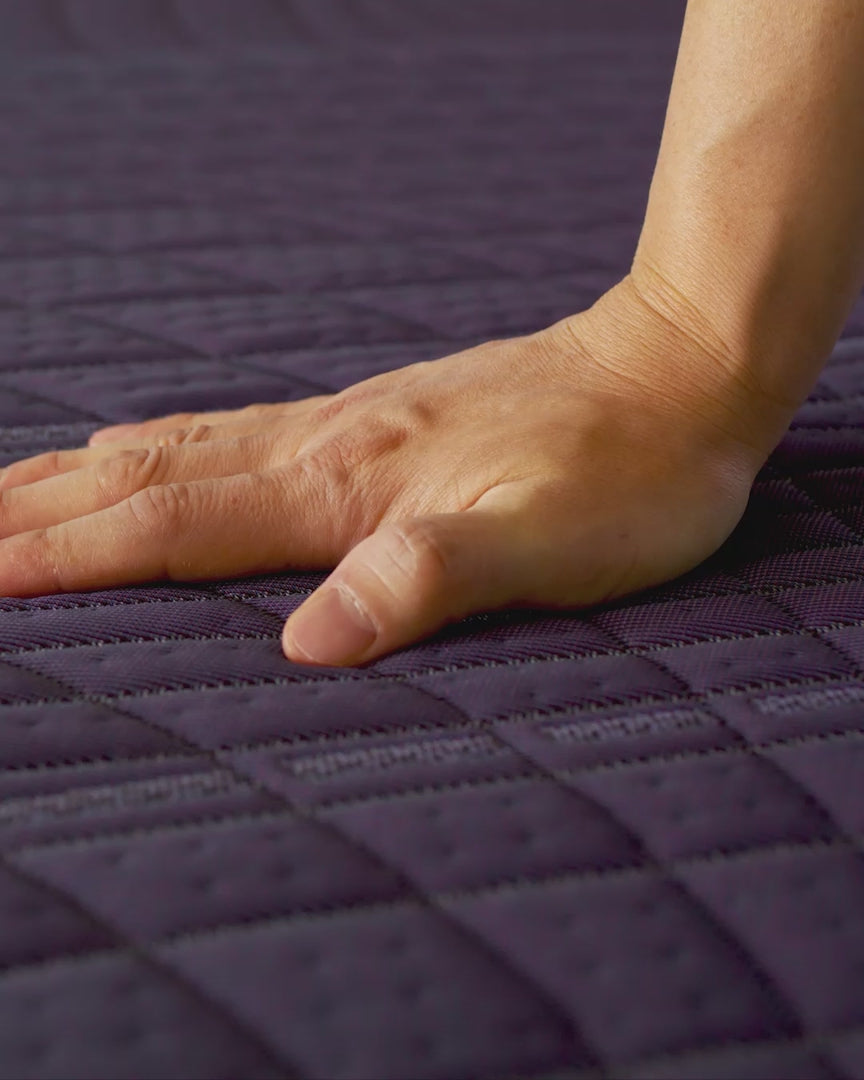 hand demonstrating softness of the purple ultimate mattress