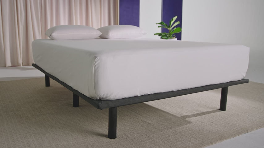 man laying in adjustable bed by purple