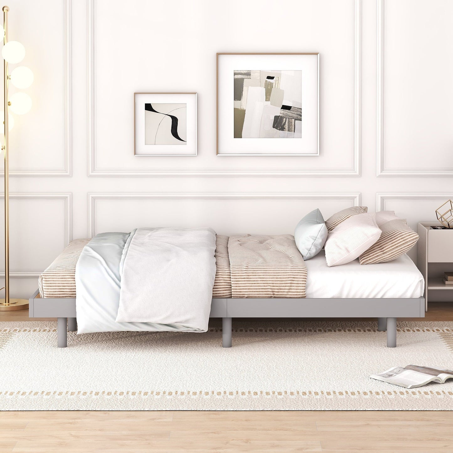 Modern bedroom with a bed, pillows, and framed art on the wall.