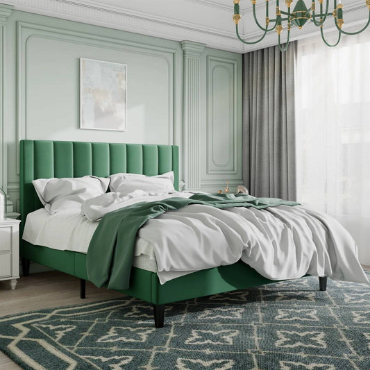 Queen size green velvet upholstered bed frame in a stylish bedroom with light green walls and a chandelier.