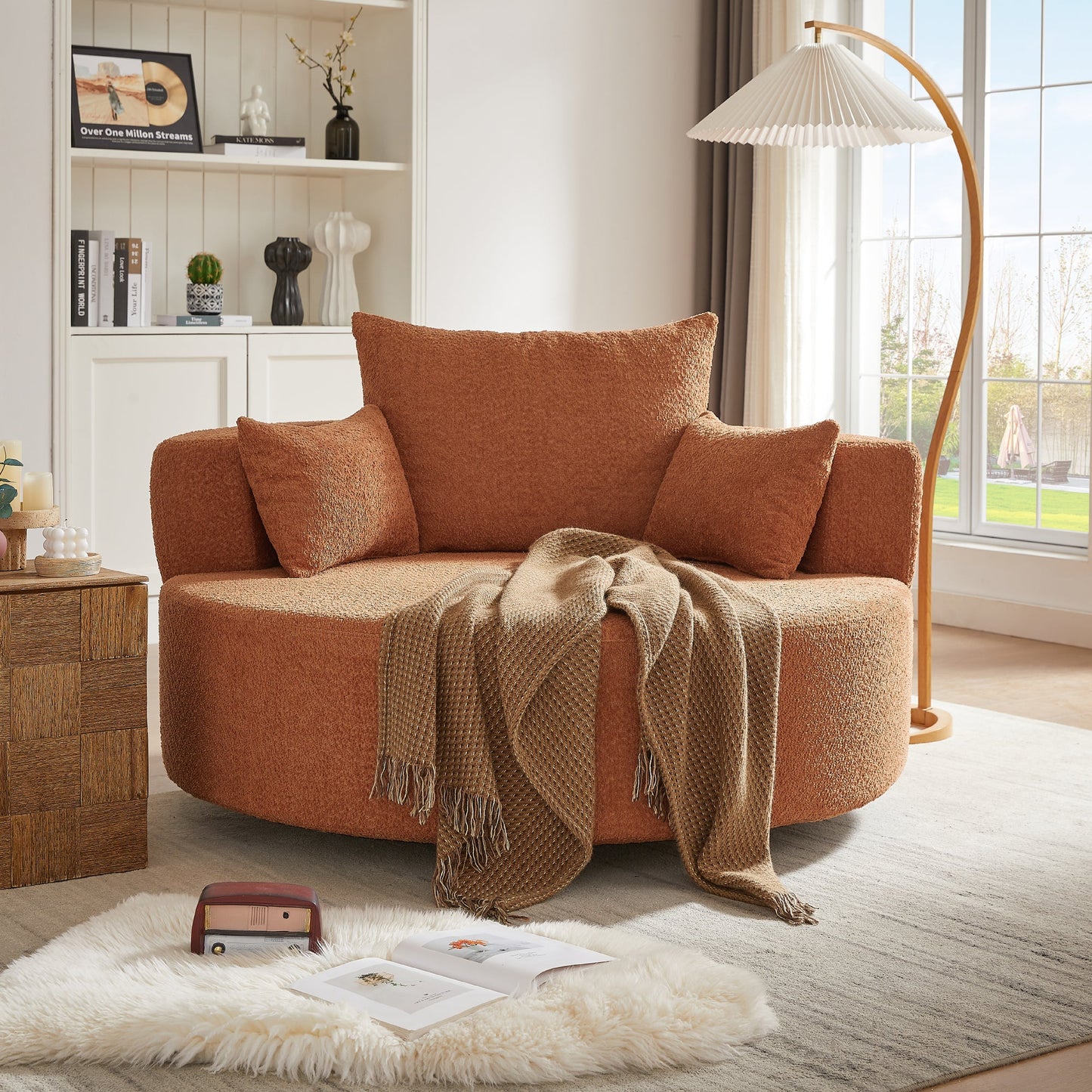 Orange accent chair with a blanket in a living room setting