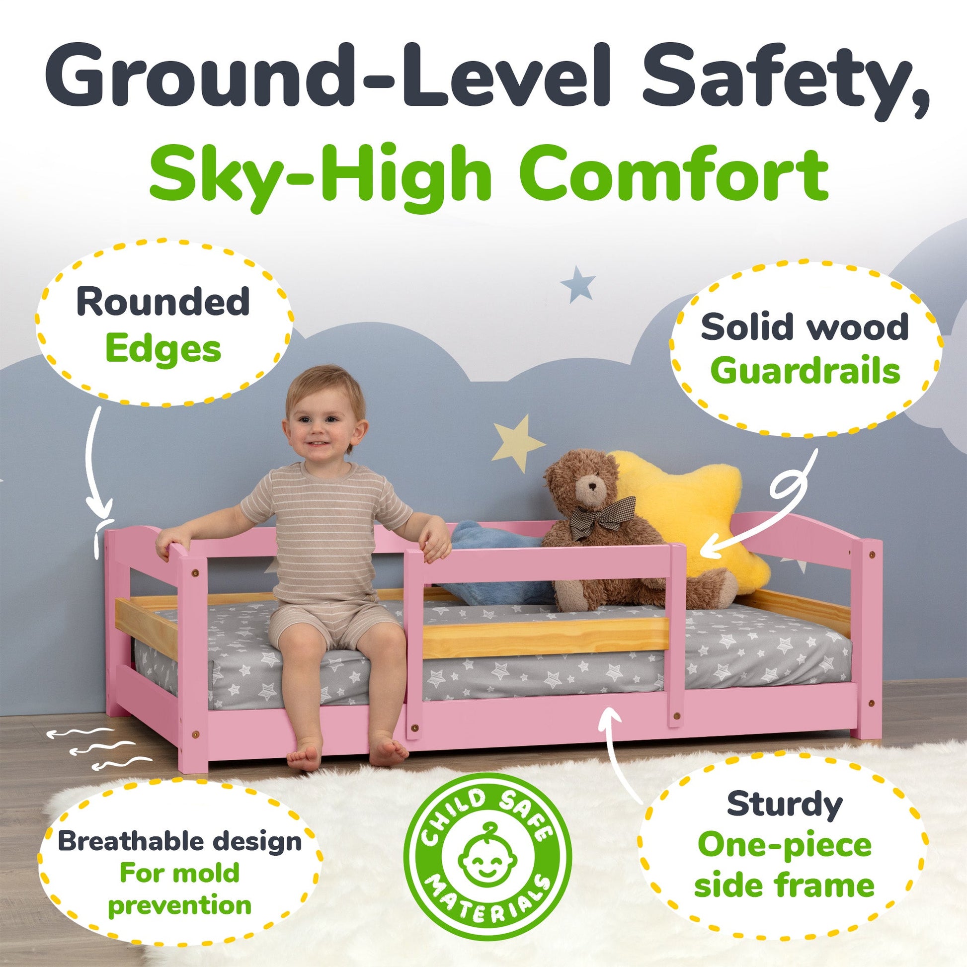 Child sitting on a pink bed with safety features highlighted, including rounded edges and solid wood guardrails.