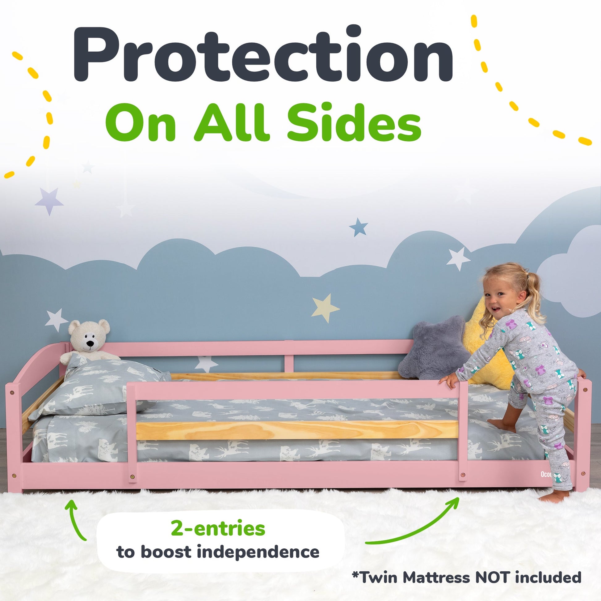 Child playing on a pink bed with a mattress guard, surrounded by teddy bears and pillows against a starry night wall.