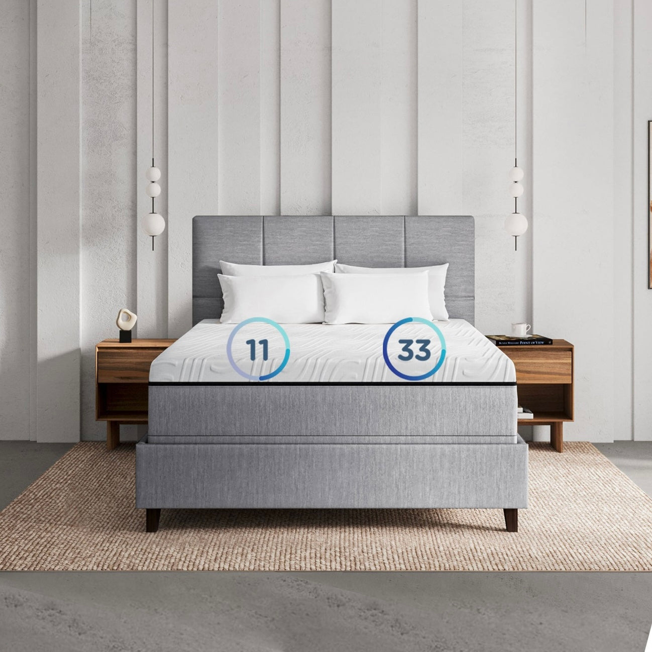 Gray upholstered number bed with white pillows in a bedroom setting