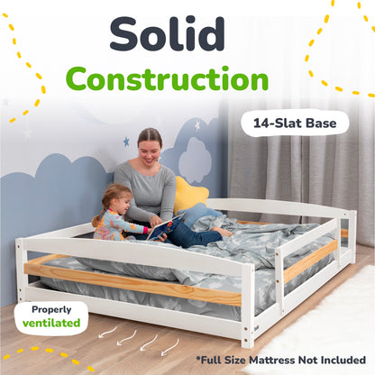 Woman and child reading in a white and wood bed with text about solid construction and 14-slat base.