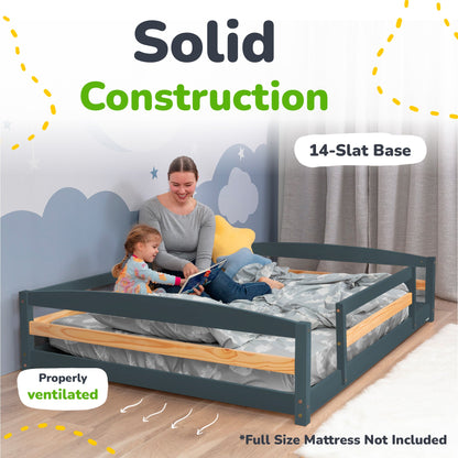Woman and child on a solid construction bed with 14-slat base and properly ventilated design.