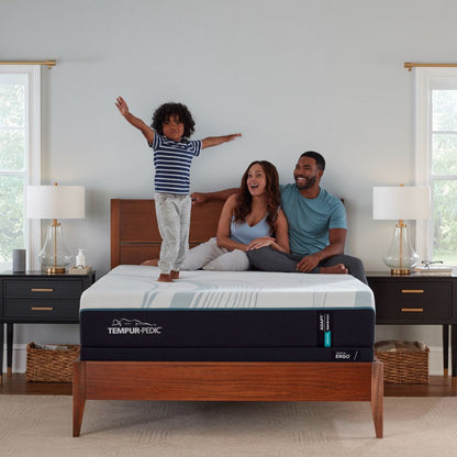 Family on a Tempur-Pedic adapt medium mattress in a bedroom setting