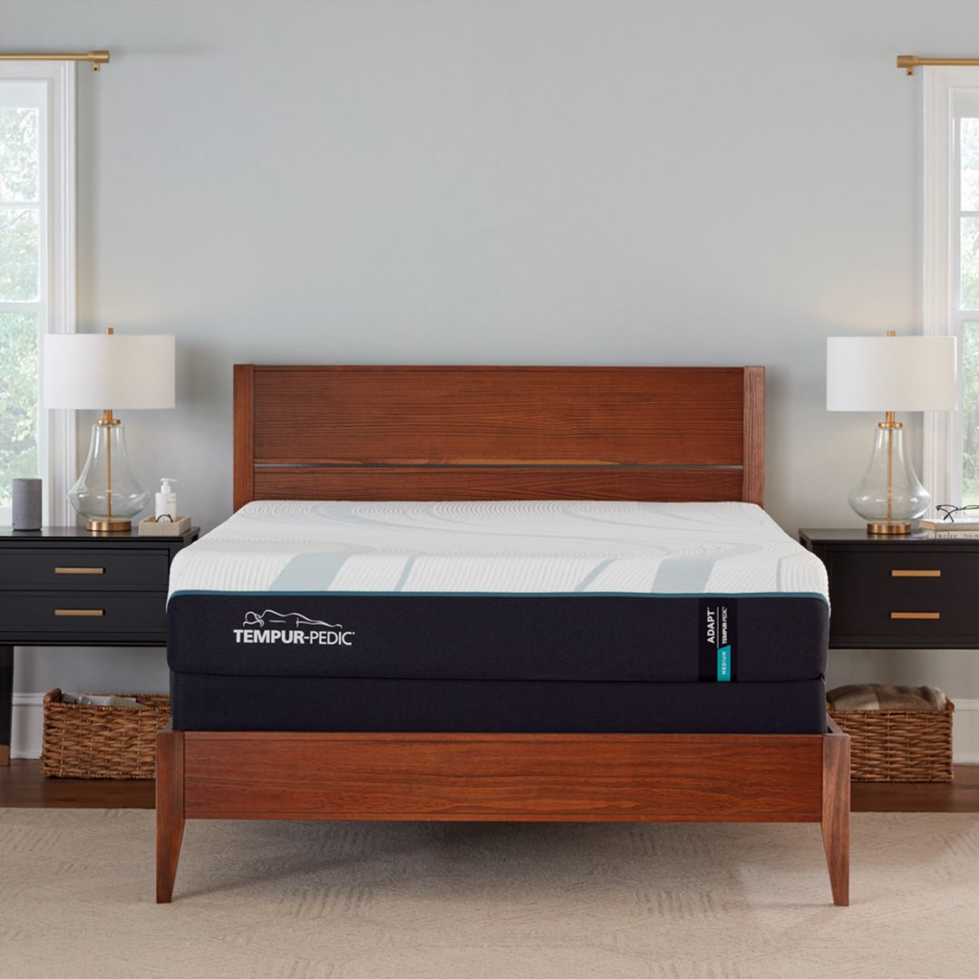 Tempur-Pedic medium adapt mattress on a wooden bed frame in a bedroom setting.