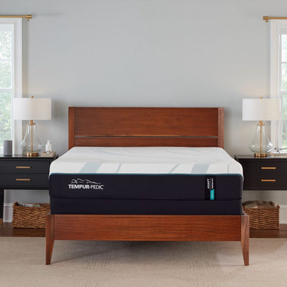 Tempur-Pedic medium adapt mattress on a wooden bed frame in a bedroom setting.