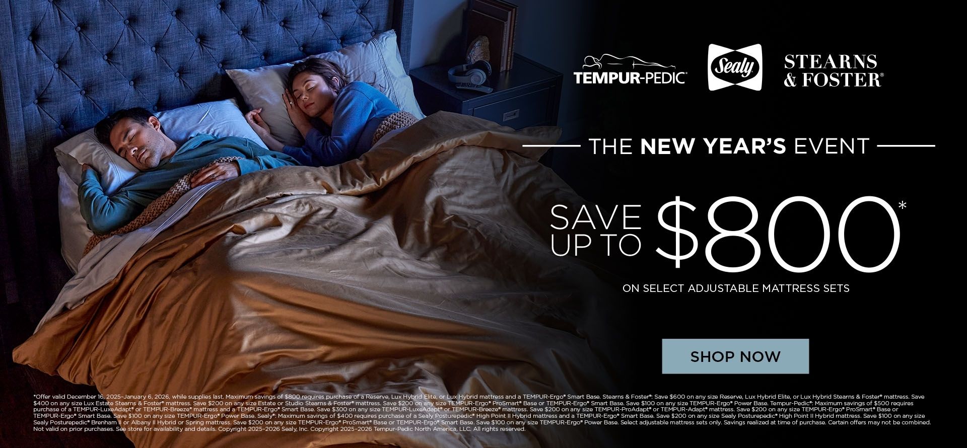 Two people lying in bed with a mattress advertisement for Stearns & Foster and Tempur-Pedic.