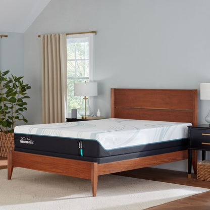 Wooden bed with Tempur-Pedic adapt medium mattress in a bedroom setting