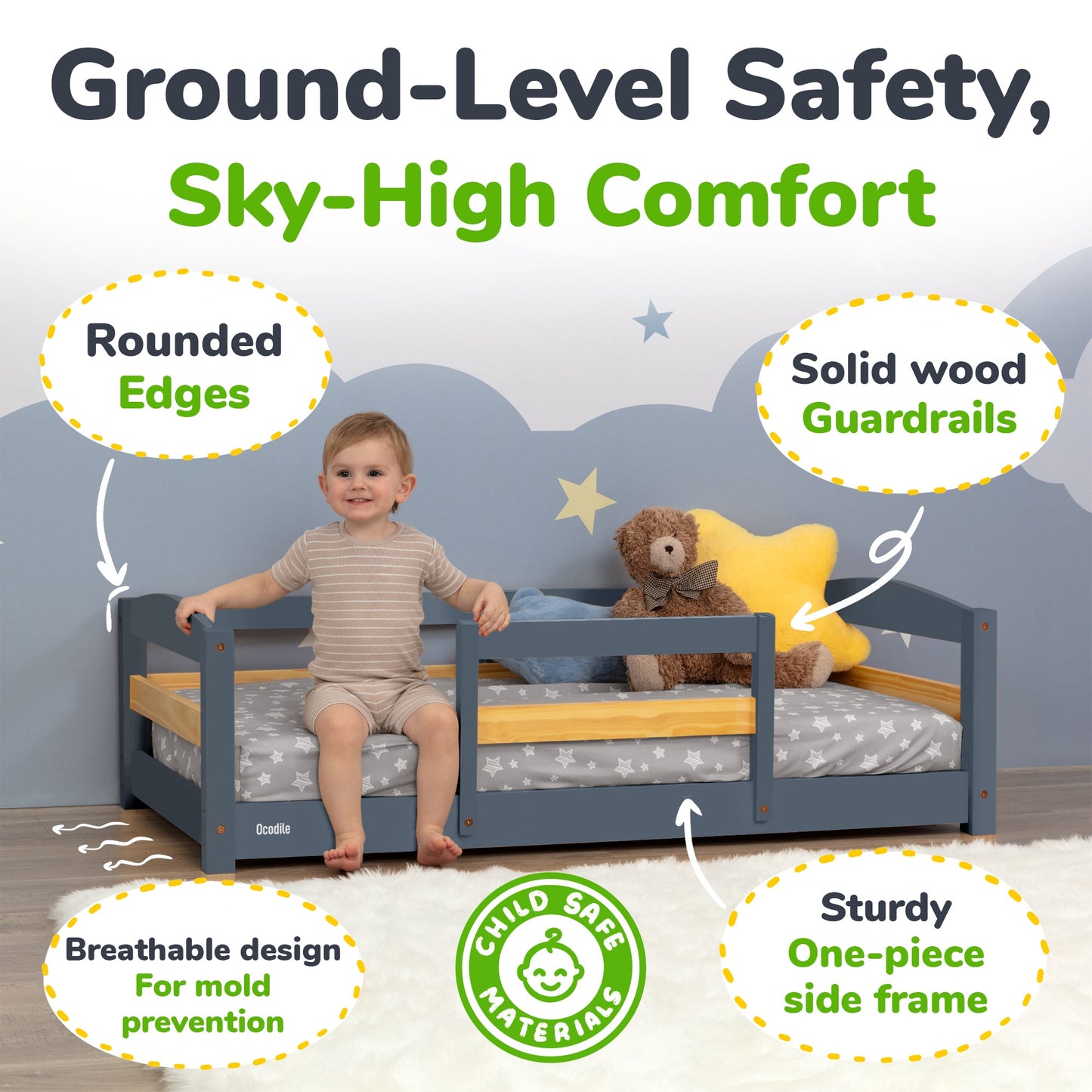 Child sitting on a toddler bed with safety features highlighted, including rounded edges and solid wood guardrails.