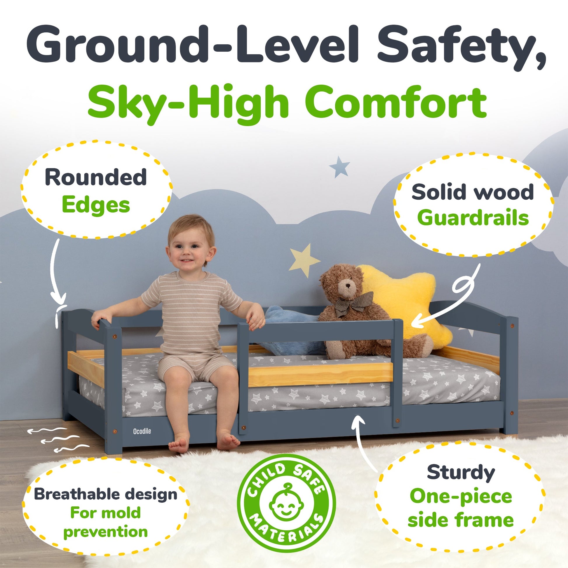 Child sitting on a toddler bed with safety features highlighted, including rounded edges and solid wood guardrails.