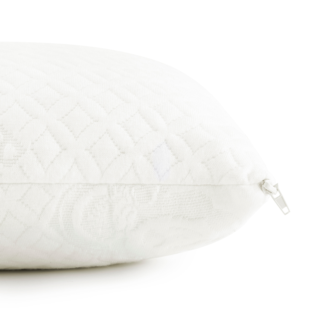 Close-up of a white quilted pillow with a zipper on a white background
