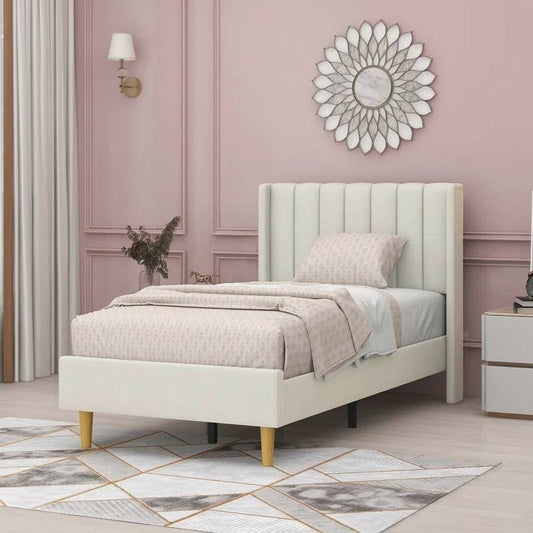 Twin cream upholstered bed in a stylish bedroom with pink walls and decorative elements.