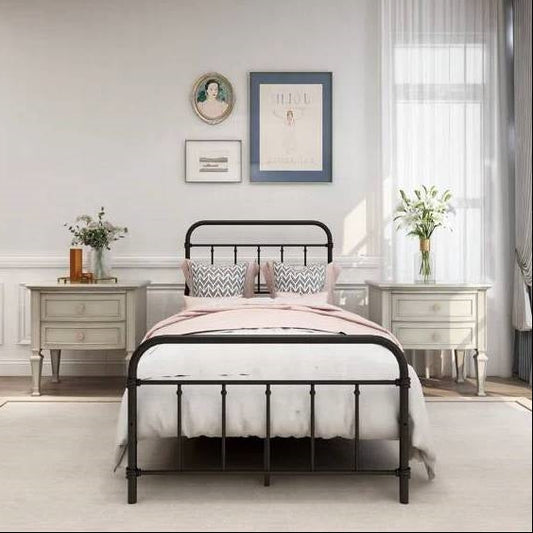 Twin black metal platform farmhouse bed frame, white bedding, and decorative pillows.