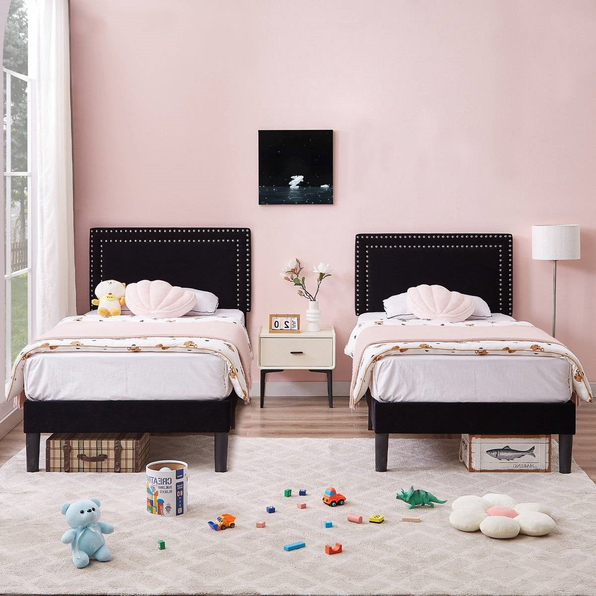 Two luxury black bed frames in pretty pink kids room