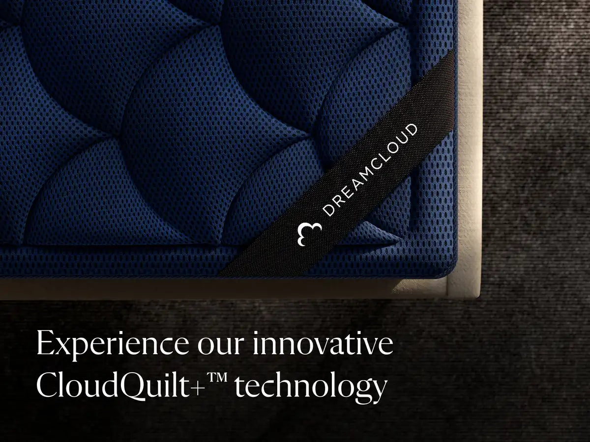 DreamCloud mattress with branding and text about CloudQuilt+ technology on a dark background