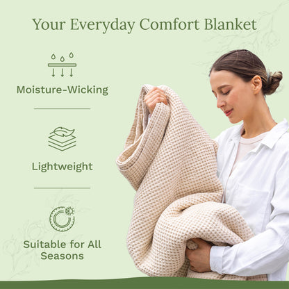 Woman holding a beige blanket with text about its features on a green background