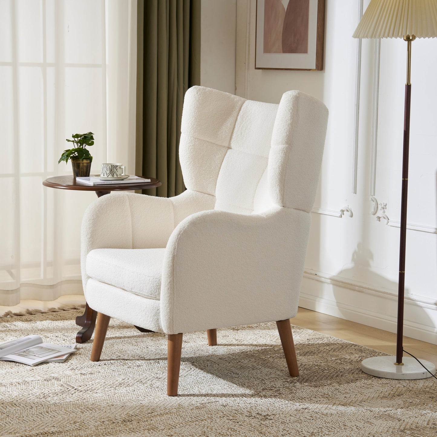 White armchair in a living room setting with a lamp and small table in the background.