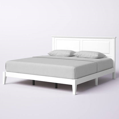 White king size wood oak bed frame with gray bedding on a white background