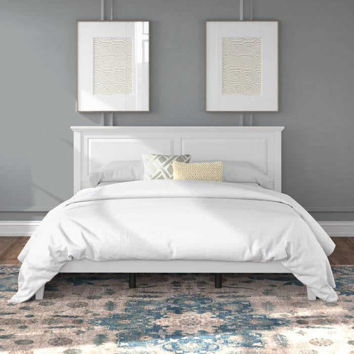 White king size oak bed frame with matching headboard against a gray wall with two framed artworks.