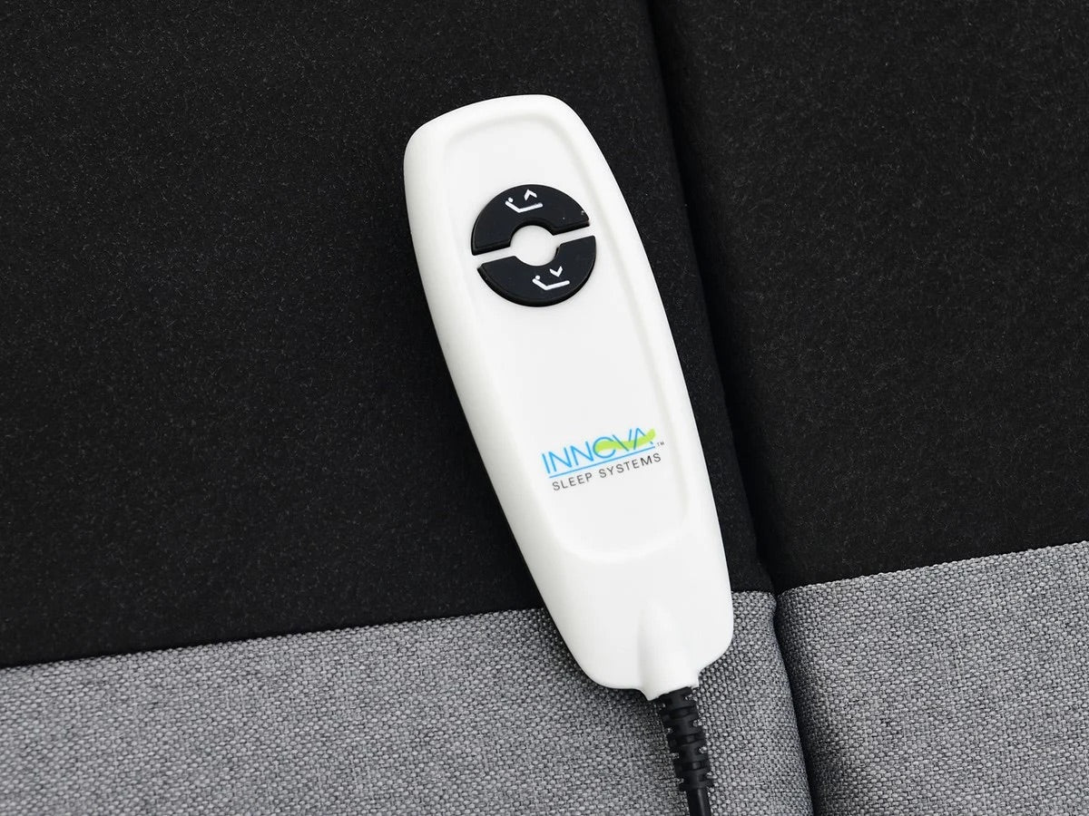 White wired adjustable base remote with 'Innova Sleep Systems' logo on a black and gray background
