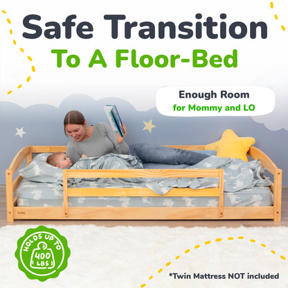 Child reading to a baby in a floor-bed with a woman, featuring text about safe transition to a floor-bed.