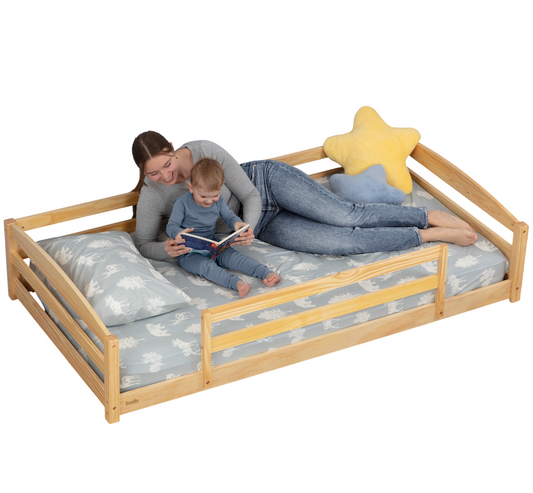 Woman and child on a wooden bed with star-shaped pillow