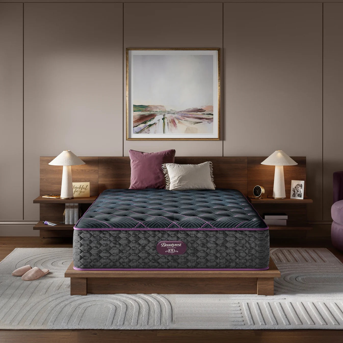 Gray mattress with purple accents on a wooden bed frame in a bedroom setting.