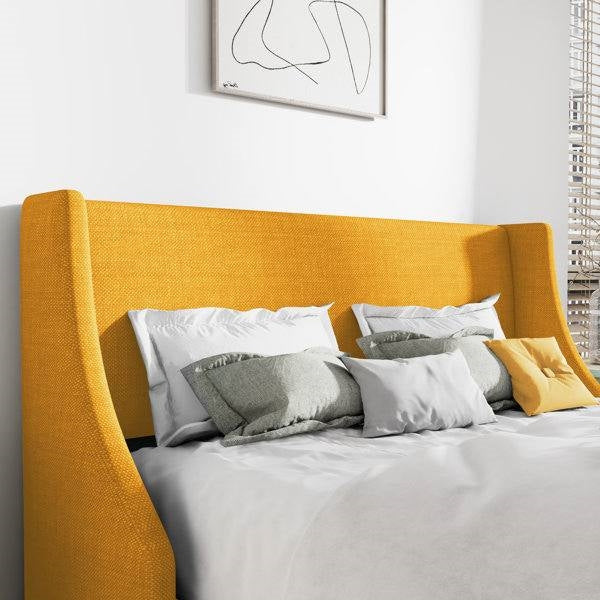 Yellow king size linen upholstered headboard with pillows